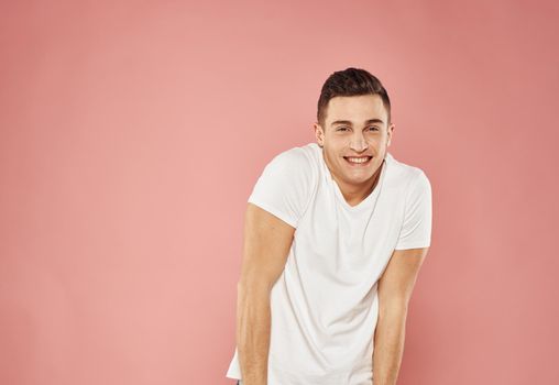Cute man in t-shirt studio pink background fun. High quality photo