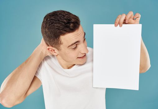 man with flyer in hand and mockup blue background cropped view. High quality photo