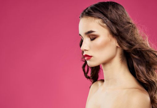 Woman on pink background with bright makeup red lips . High quality photo