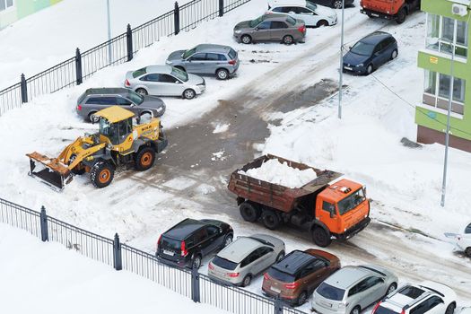 Nizhny Novgorod, Russia, Gagarin Avenue 101 k.1, 2021.03.03. Snowplows in the yards and streets of the city. High quality photo