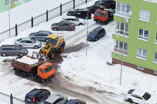 Nizhny Novgorod, Russia, Gagarin Avenue 101 k.1, 2021.03.03. Snowplows in the yards and streets of the city. High quality photo