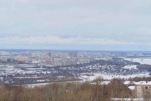 Panoramic view from above of a large industrial city by the river in winter. High quality photo