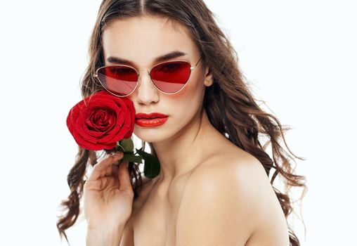 Charming woman with red rose brunette sunglasses. High quality photo