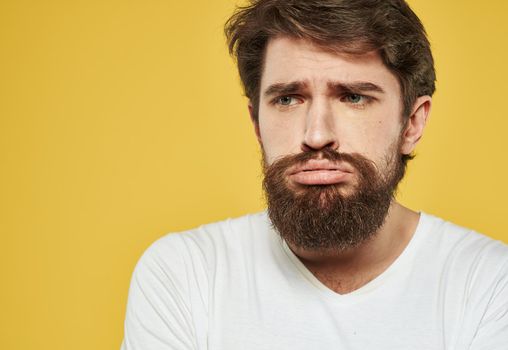 Portrait of a nice guy sad face yellow background cropped view. High quality photo
