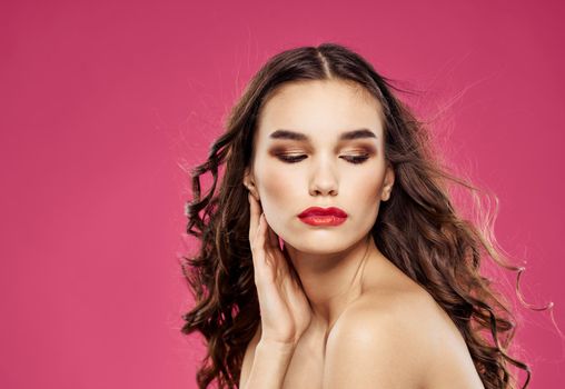 Romantic woman with red lips posing on a pink background. High quality photo