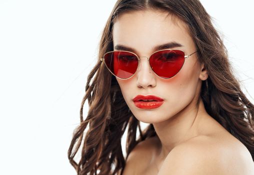 Romantic woman model in glasses on a light background close-up. High quality photo