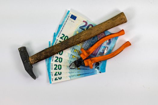 of 20 euro banknotes with work tools on a white background