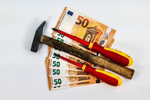 of 50 euro banknotes with work tools on a white background