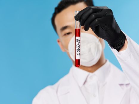 Man of Asian appearance Laboratory blood test examination research coronavirus. High quality photo