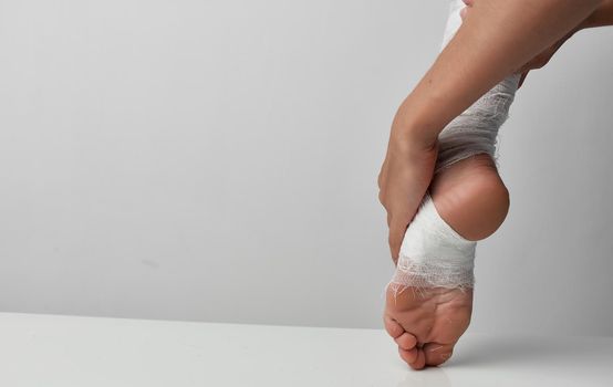 bandaged leg injury medicine gray background problems. High quality photo