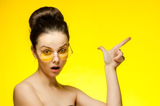 brunette paired keys fashionable yellow glasses close-up model. High quality photo
