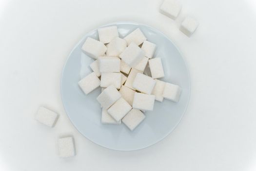 refined sugar cubes on a plate energy calories. High quality photo