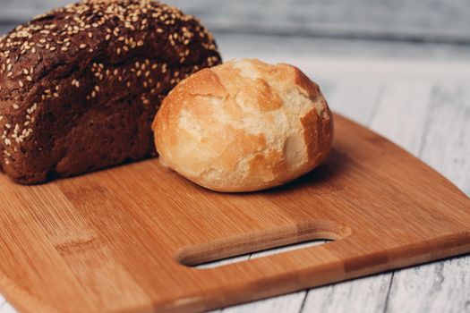loaf of bread on a wooden board powerful products food. High quality photo