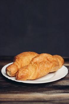 croissants on a white plate red mug kitchen appliances breakfast. High quality photo