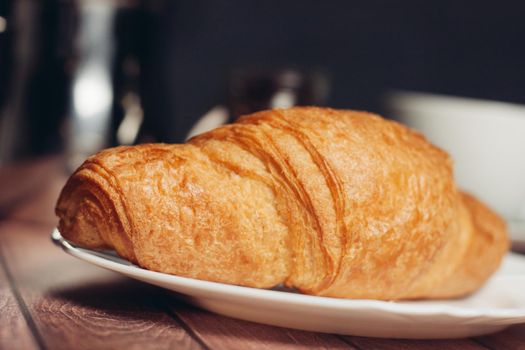 fresh croissants on a plate on the table breakfast dessert. High quality photo