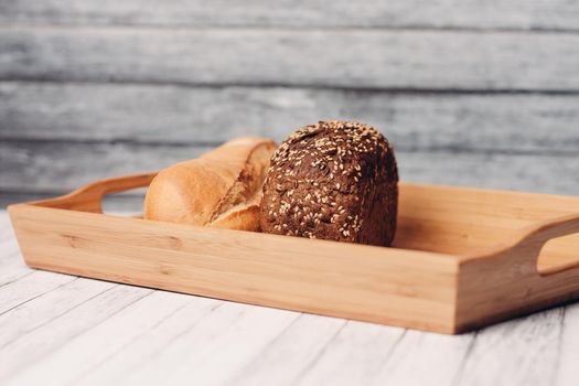 white dark bread whole grain homemade cakes wooden tray breakfast. High quality photo