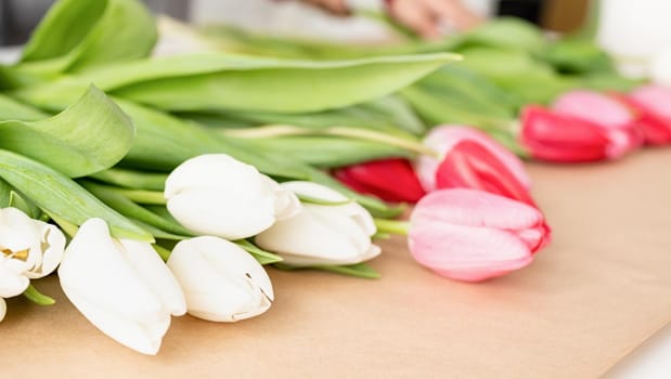 Valentine's Day and Women's Day. Small business. Fresh tulips on craft wrapping paper, front view