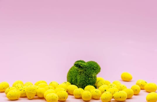Yellow Easter Egg with freckles pattern and Rabbit Bunny on Pink Background