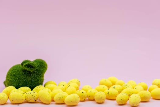 Yellow Easter Egg with freckles pattern and Rabbit Bunny on Pink Background