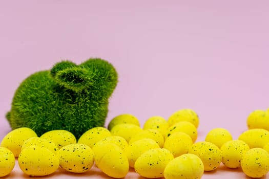 Yellow Easter Egg with freckles pattern and Rabbit Bunny on Pink Background