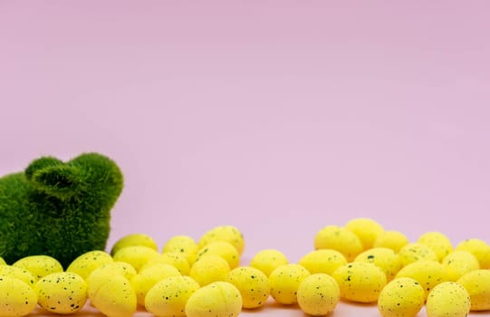 Yellow Easter Egg with freckles pattern and Rabbit Bunny on Pink Background