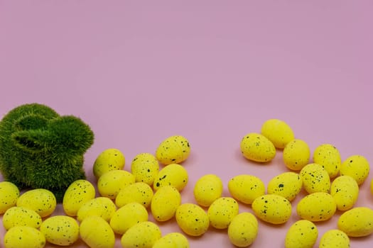 Yellow Easter Egg with freckles pattern and Rabbit Bunny on Pink Background