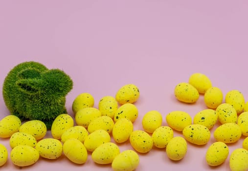 Yellow Easter Egg with freckles pattern and Rabbit Bunny on Pink Background