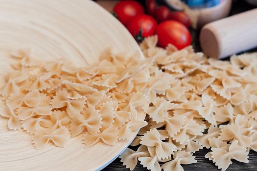 Italian pasta kitchen cooking wood table ingredients cherry tomatoes. High quality photo
