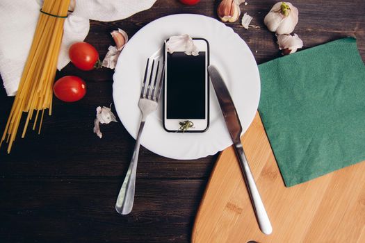 phone in a plate kitchenware cooking pasta italy. High quality photo