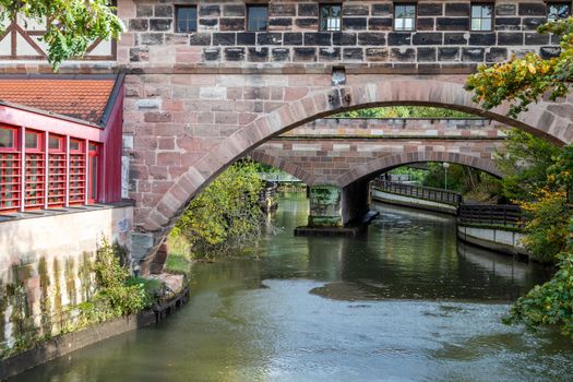 Bridge over Pegnitz river in Nuremberg,  Bavaria, Germany  in autunm with multicolored trees