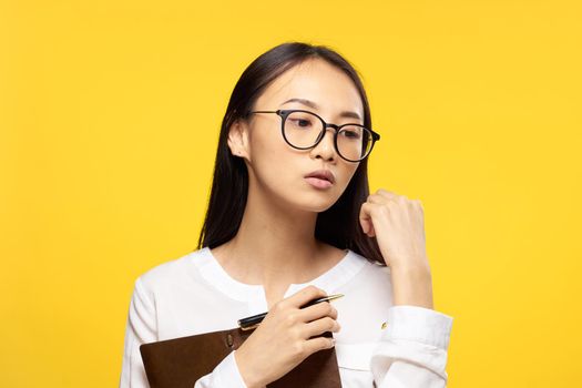 woman asian appearance secretary work office yellow background. High quality photo