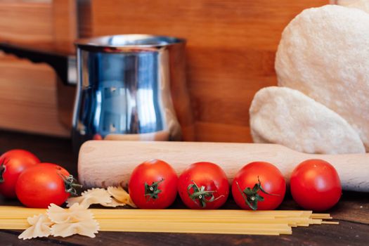 italian pasta cherry tomatoes cooking food kitchen wooden table. High quality photo