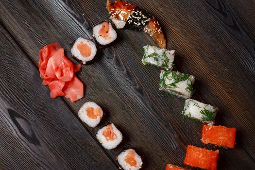 sushi rolls chopsticks japanese cuisine delivery meal wooden table. High quality photo