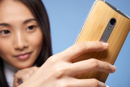woman of asian appearance with a phone in hands communication internet technology. High quality photo