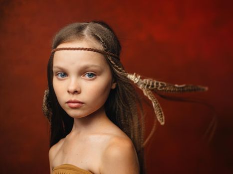 girl with a feather in her hair savage aboriginal shaman indian tribe. High quality photo