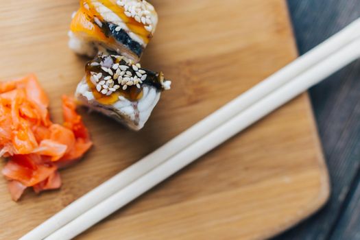 sushi chopsticks wood board restaurant top view. High quality photo