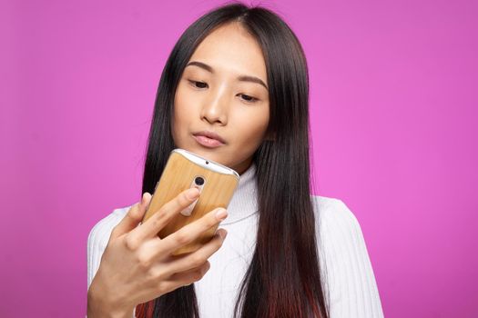 pretty woman with a phone in her hands looking at the screen internet communication technology. High quality photo