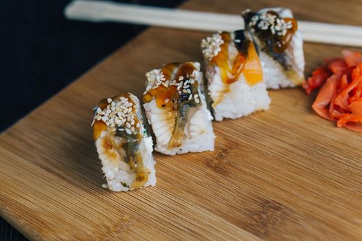red ginger sushi chopsticks wooden board meal gourmet. High quality photo