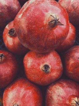 Harvest of ripe pomegranates in a box. Red tropical fruits.