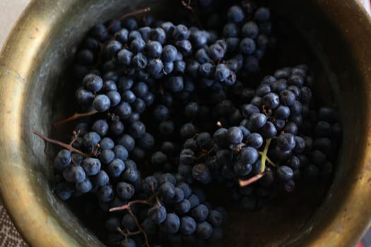 The grapes are blue ripe in a bucket, a view from above. High quality photo