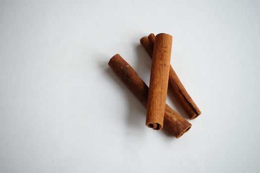  Cinnamon, dried sticks on a white background with fragrant tea