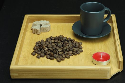 Natural coffee beans on a wooden tray with a coffee cup. High quality photo