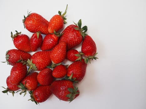 Ripe red strawberry berries on a white background. High quality photo