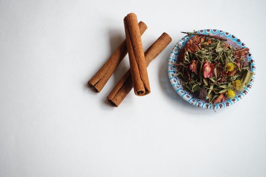  Cinnamon, dried sticks on a white background with fragrant tea