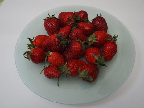 Ripe strawberries. Ripe red berries on a platter. High quality photo