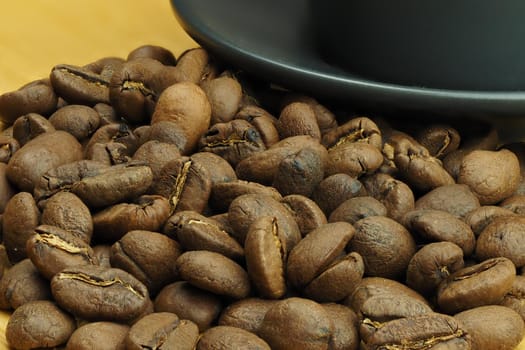 Beautiful background and coffee beans and a coffee cup in the background. High quality photo