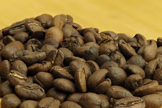 The beautiful background of their coffee is cereal. Brown background of natural coffee grains, macro-making. High quality photo