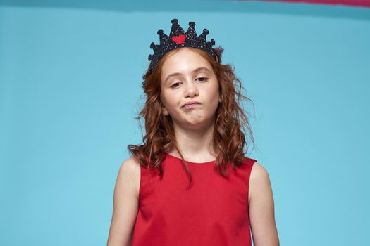 Girl in red dress with curly hair fun lifestyle blue background. High quality photo