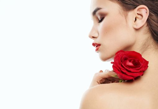 sexy woman with red flower on shoulder on light background cropped back view. High quality photo