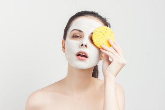 emotional brunette cream face mask bare shoulders cropped view clear skin. High quality photo